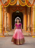Girls Embroidered Paithani Pattu Pavadai Set in Pink - festive lifestyle shot in traditional setting